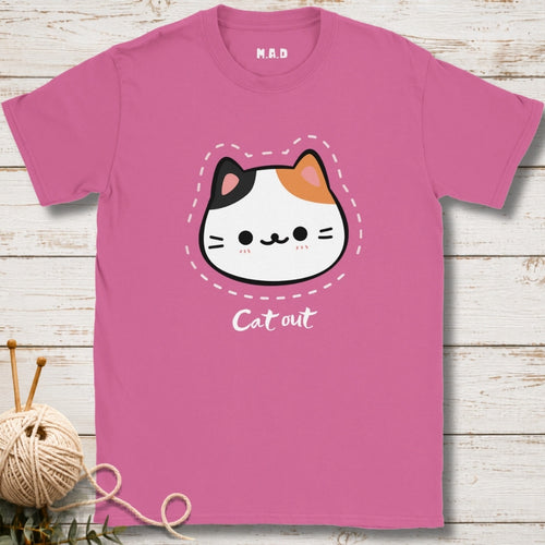 Pink t-shirt with a cat graphic and 'Cat out' text on a wooden surface.
