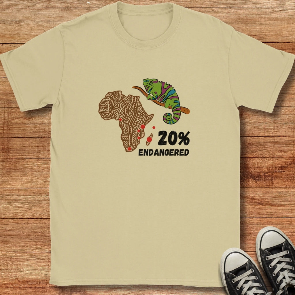 Beige t-shirt with a graphic of Africa, a chameleon, and text on a wooden surface
