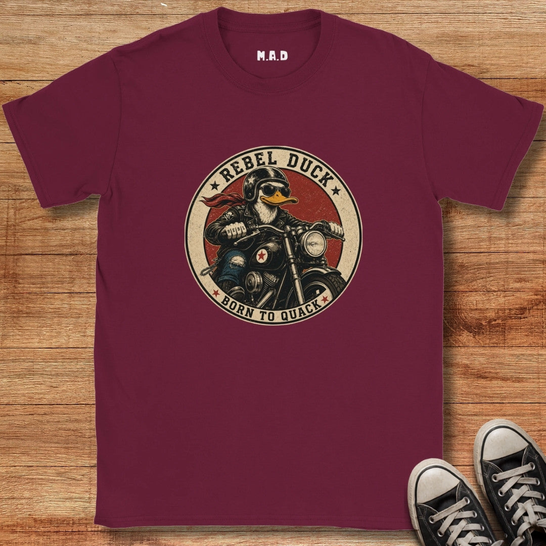 Maroon t-shirt with 'Rebel Duck' graphic on a wooden surface