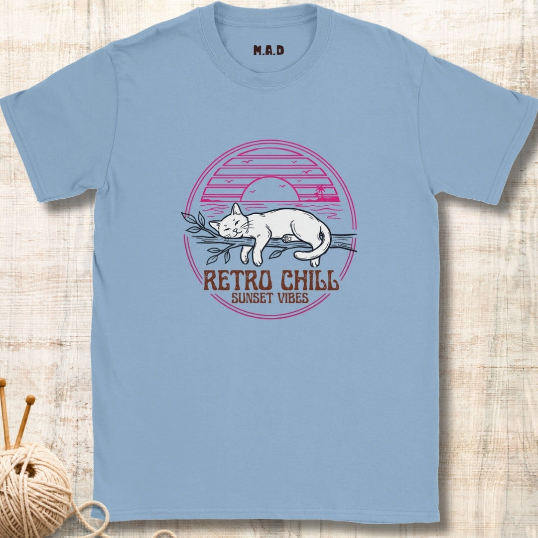 Light blue t-shirt with a cat graphic and 'Retro Chill Sunset Vibes' text on a textured surface.