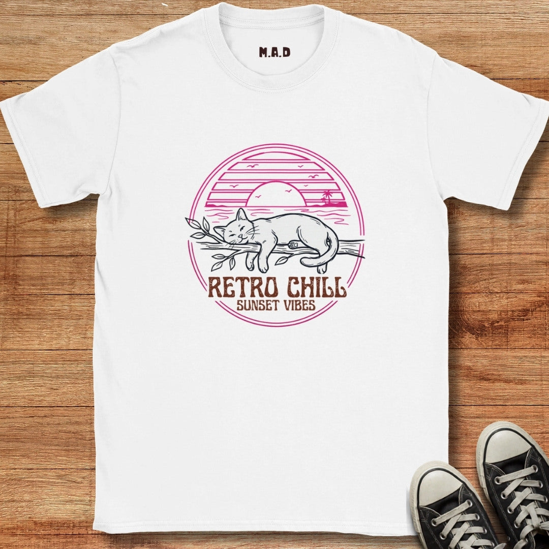 White t-shirt with 'Retro Chill Sunset Vibes' design on a wooden surface with black sneakers.