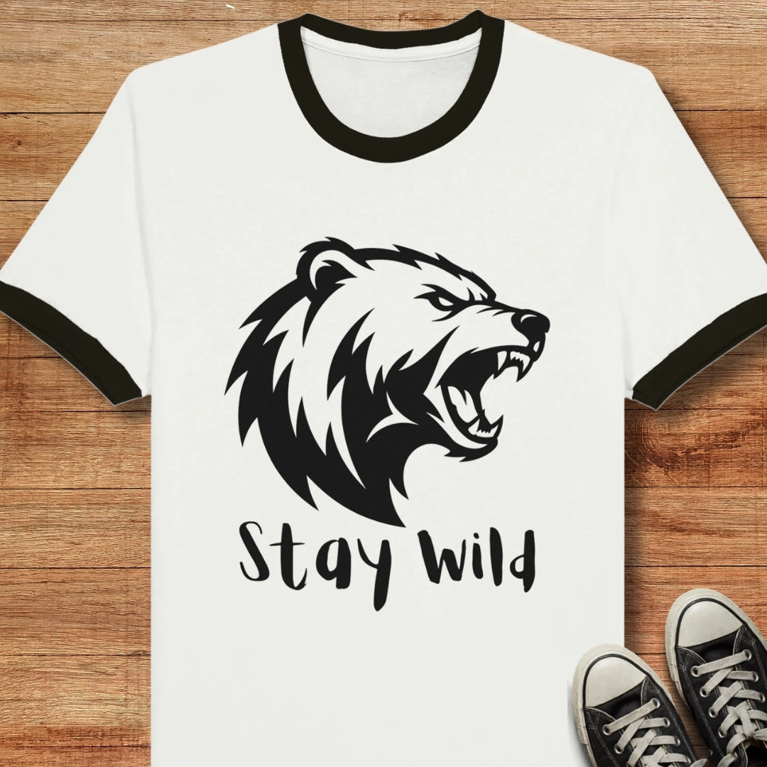 White t-shirt with black bear graphic and 'Stay Wild' text on a wooden surface