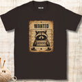 Brown t-shirt with a raccoon 'Wanted' poster design on a textured surface.