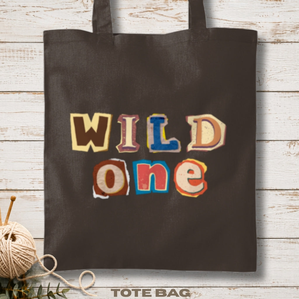 Black tote bag with 'WILD one' text in colorful letters.